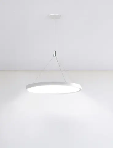 A round, white pendant light in a white room