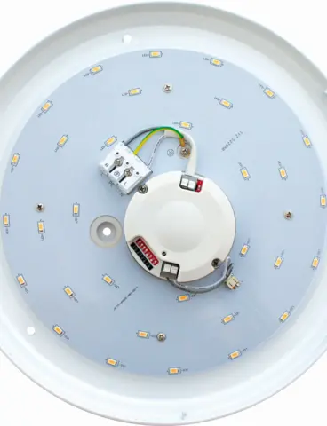 The inner workings of a round, white ceiling light