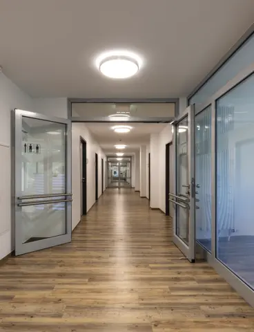 A corridor in an administrative building with ceiling lights