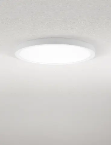 A round, white ceiling light with direct light on a white ceiling