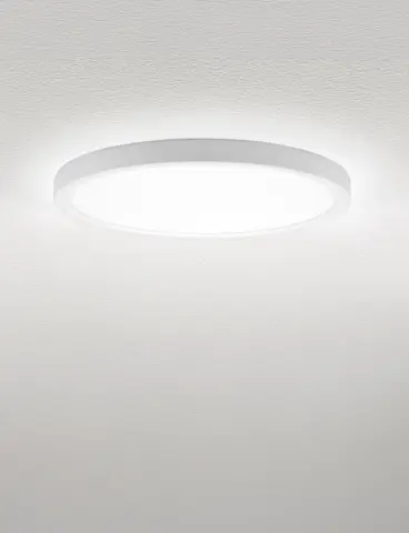 A round, white ceiling light providing direct and indirect lighting on a white ceiling